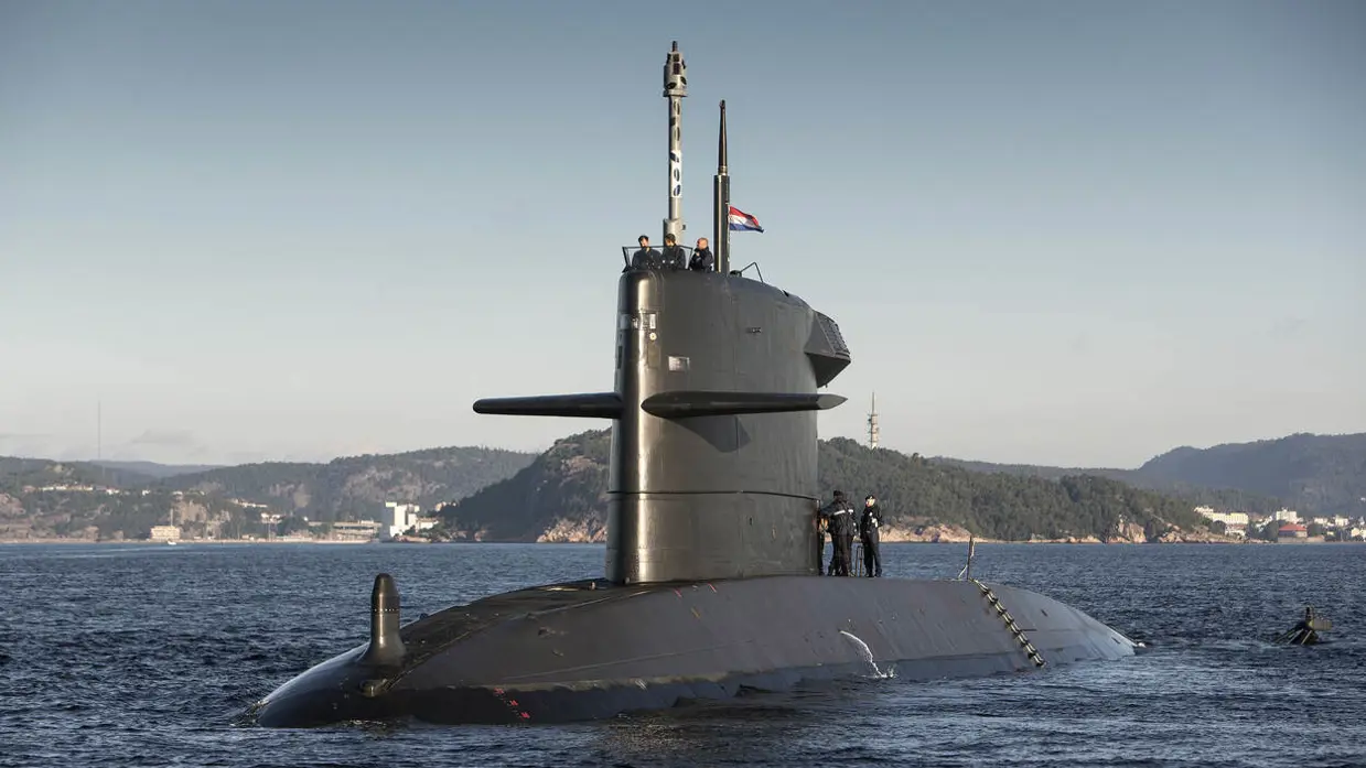 Militairen staan op een varende onderzeeboot.